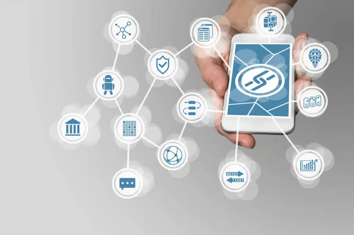 The blockchain concept with a hand holding a modern smartphone as an example for fintech technology.
