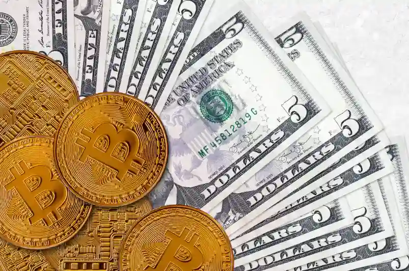 5 US dollar bills and golden bitcoins. Cryptocurrency investment concept.