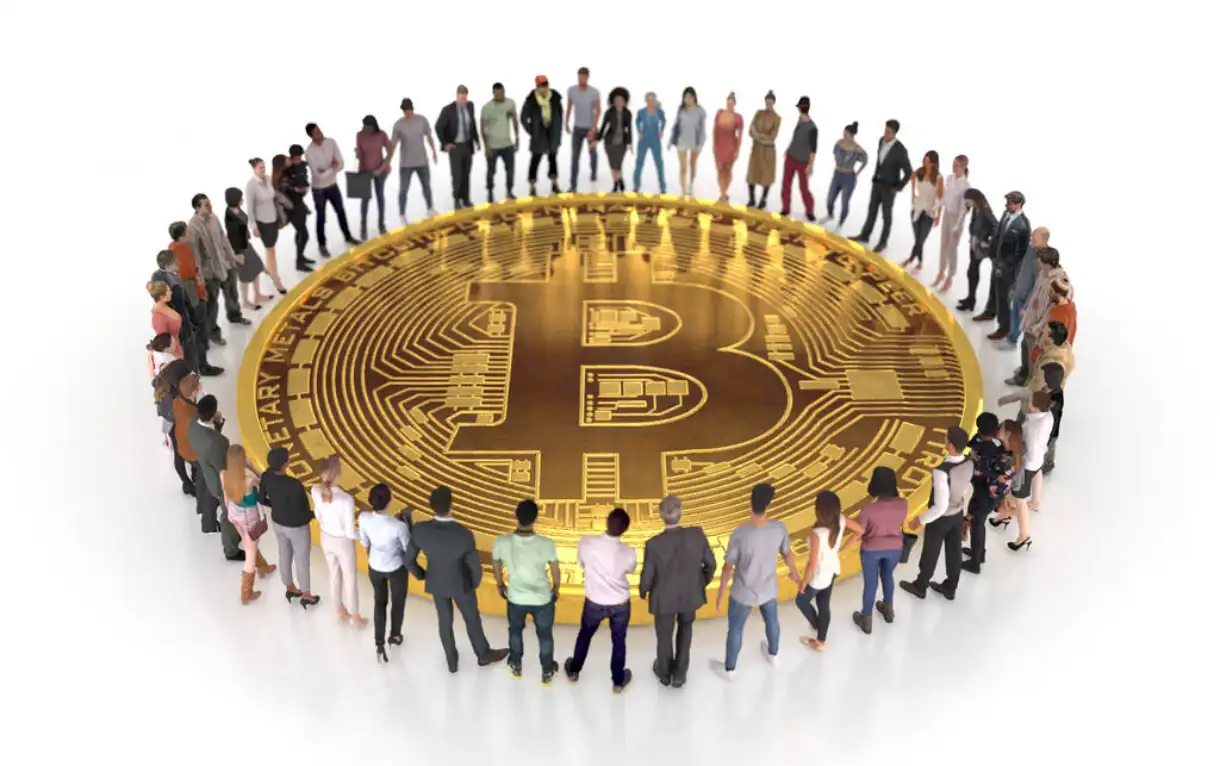 People gathering around a huge bitcoin.