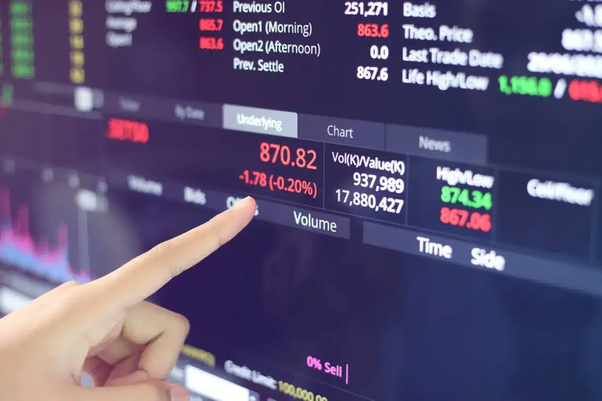 A hand pointing at numbers on the screen.