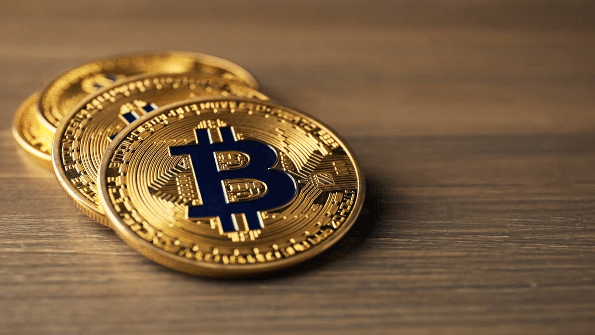 Some few bitcoin tokens on the table surface.